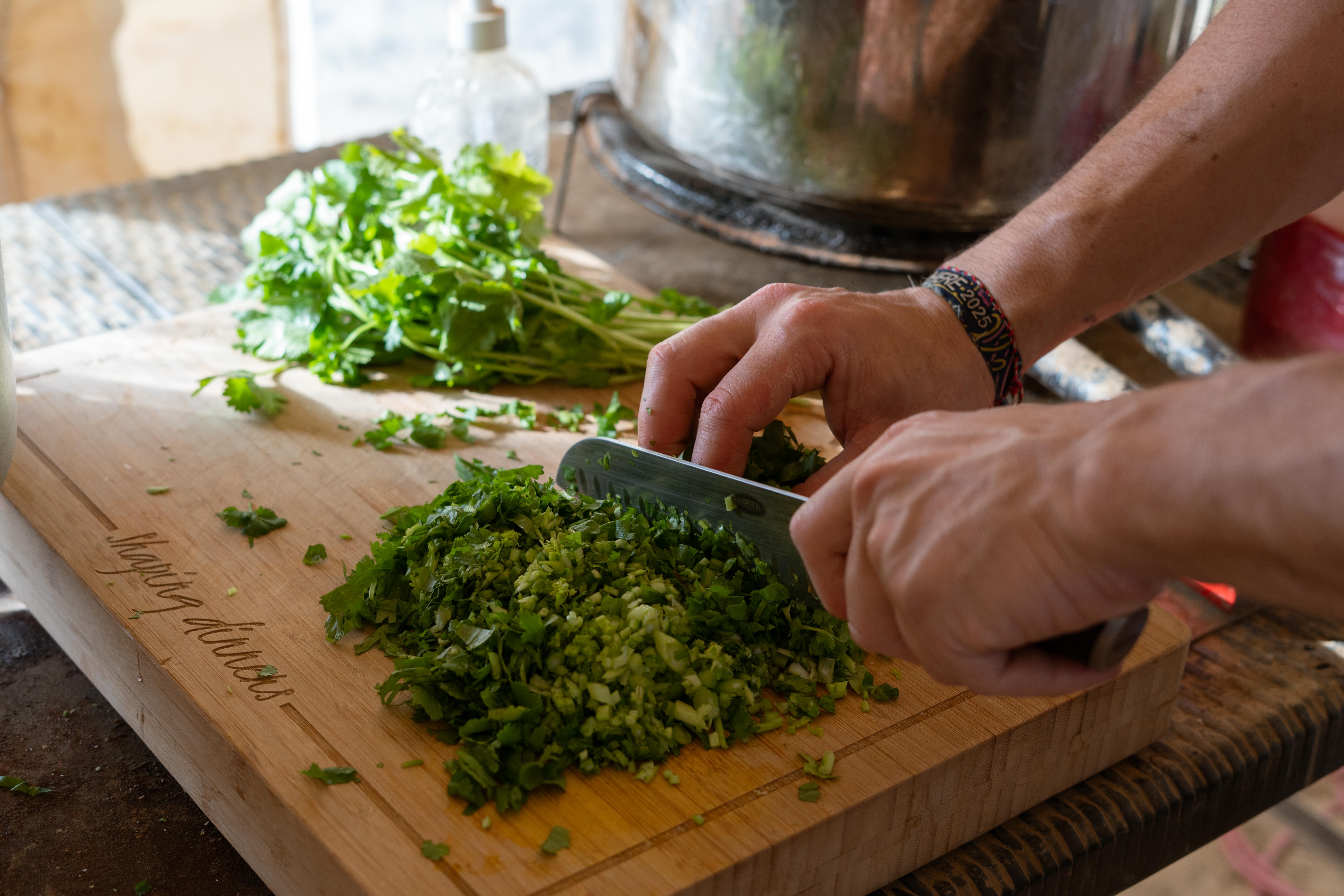 Chopping fresh herbs in the barrio kitchen
