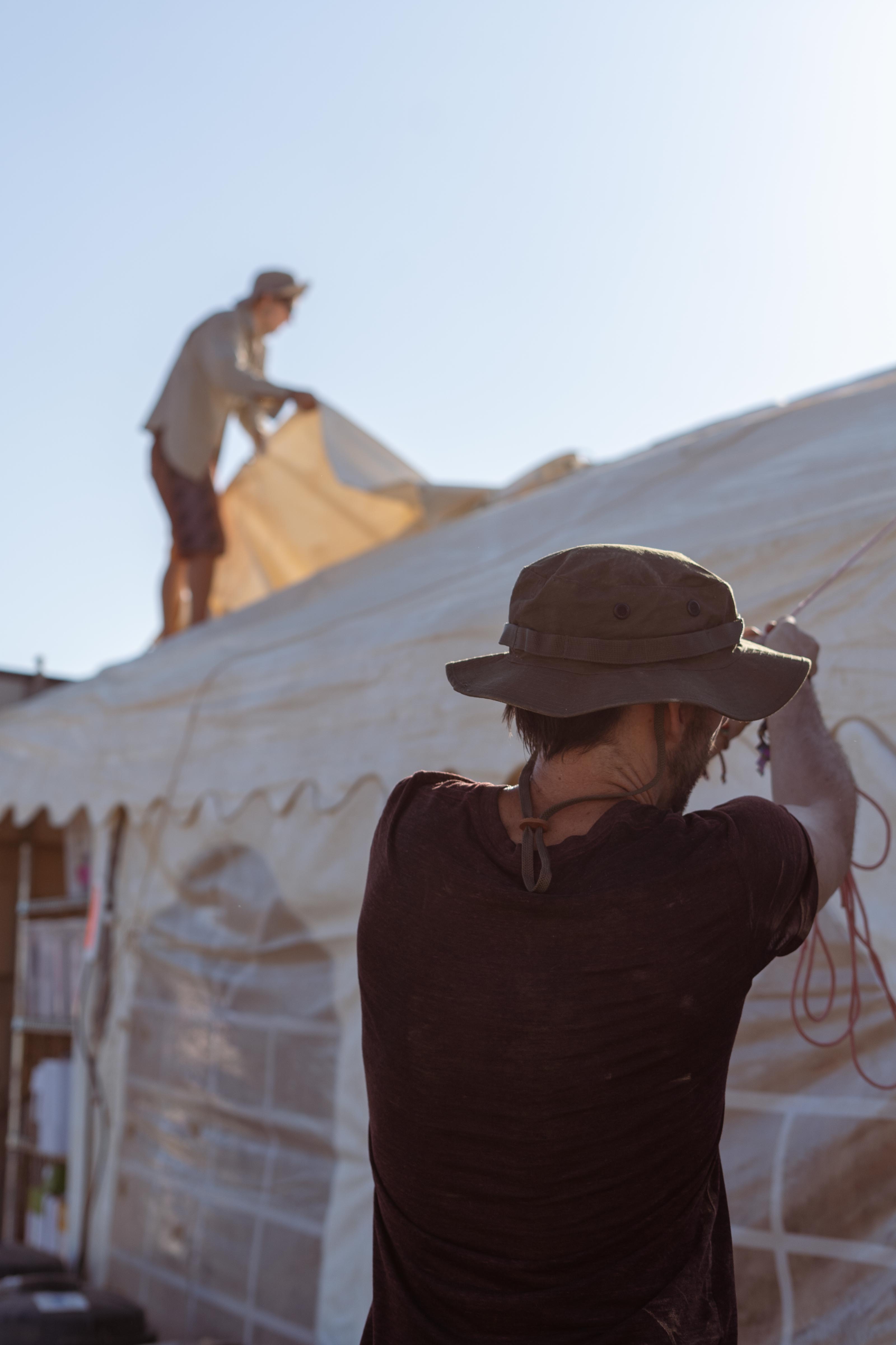 Raising a tent together at Barrio YES!